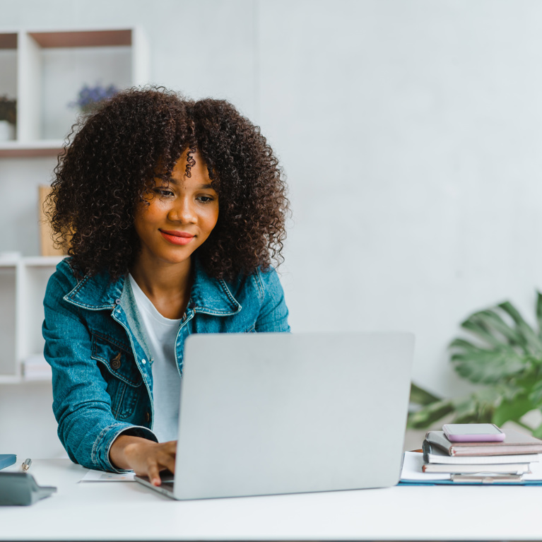 A woman working at a laptop